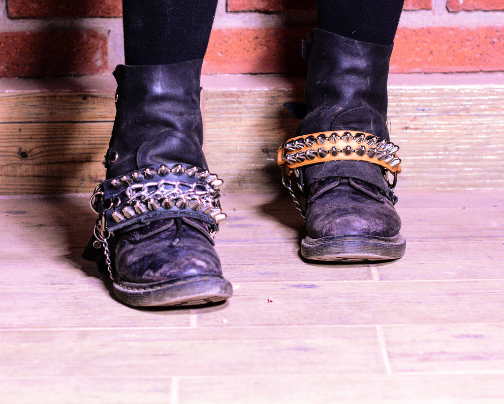 Straps with studs and chain.